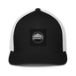 Black Flexfit 6511 closed-back trucker cap with mesh back and adjustable strap, stylish and breathable headwear.