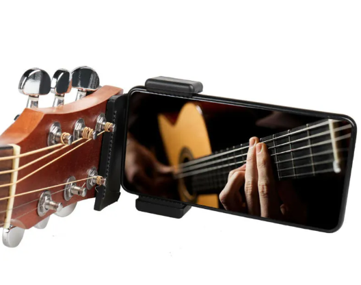 Black phone guitar clip stand from BackupMyFilesNow.com, holding a smartphone in a secure, adjustable mount.