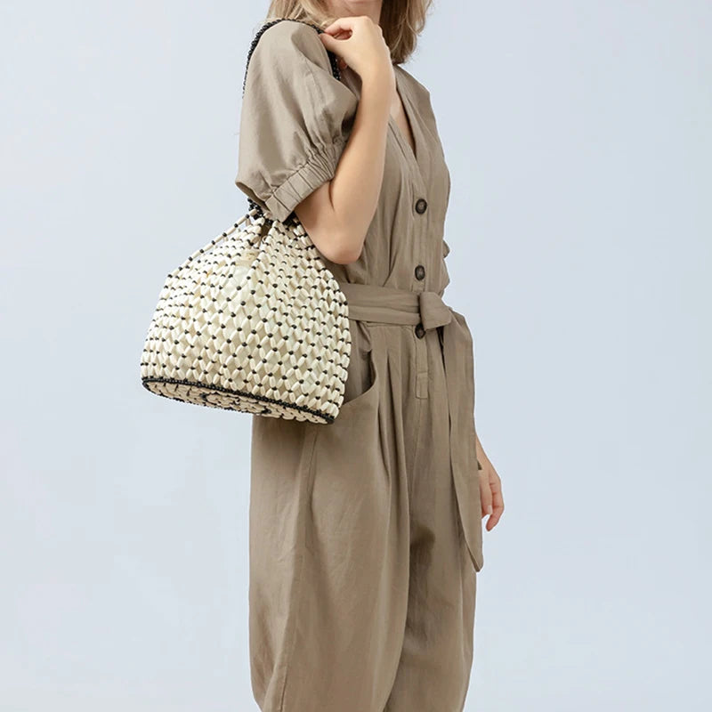 Black woven wooden bead handbag with retro design, versatile summer vacation style, handheld and shoulder carry options.