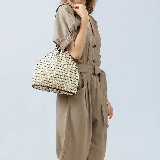 Black woven wooden bead handbag with retro design, versatile summer vacation style, handheld and shoulder carry options.