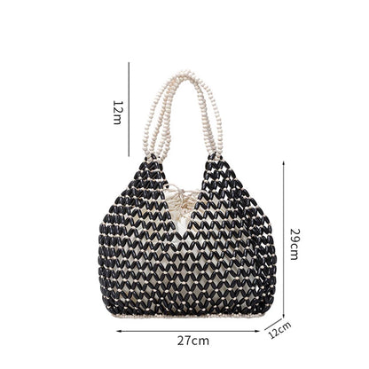 Black woven wooden bead handbag with retro design, versatile summer vacation bag, handheld and shoulder style, water bucket shape.