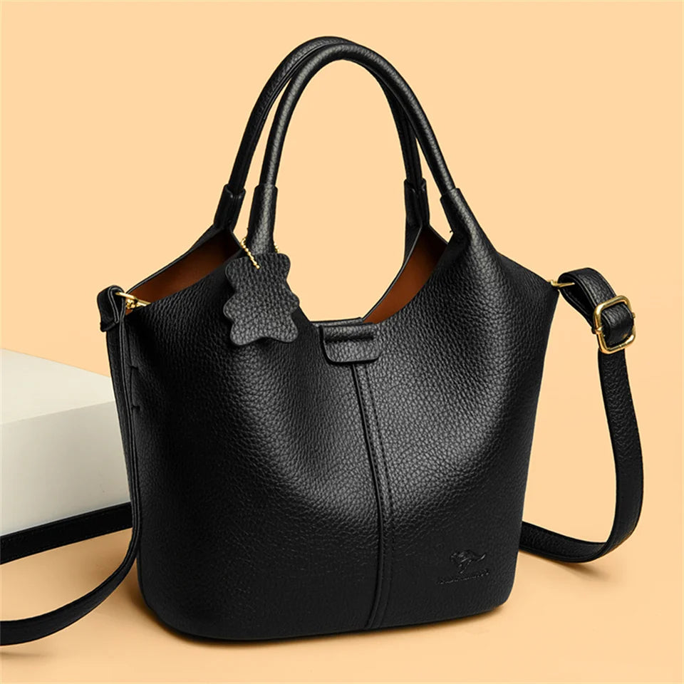 Black soft leather women's vintage shoulder handbag with large capacity, luxury designer style, featuring sturdy straps and elegant design.