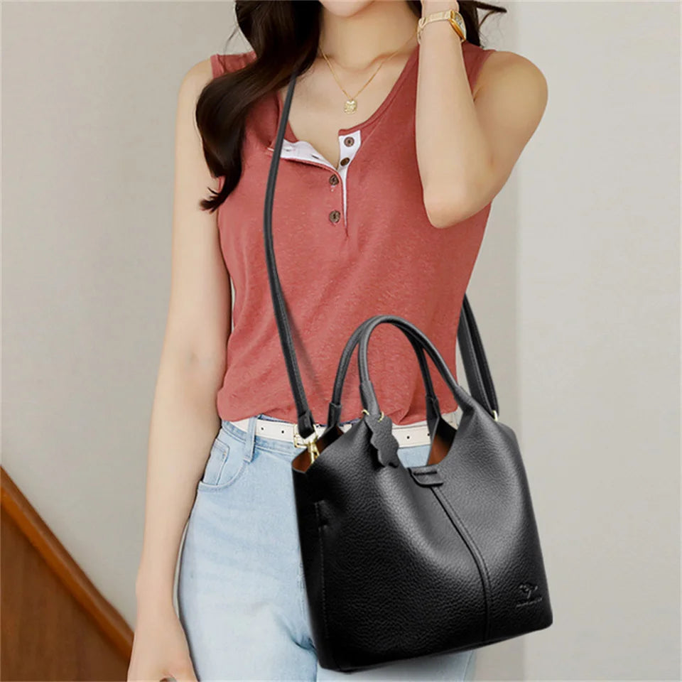 Black soft leather women's vintage shoulder handbag with large capacity, luxury designer style, featuring a classic and elegant design.