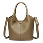 Black soft leather women's handbag featuring vintage design, large capacity, luxury style, with shoulder strap and elegant craftsmanship.