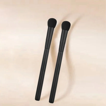 High-quality flat blush makeup brush with synthetic hair and black handle, designed for precise cheek application.