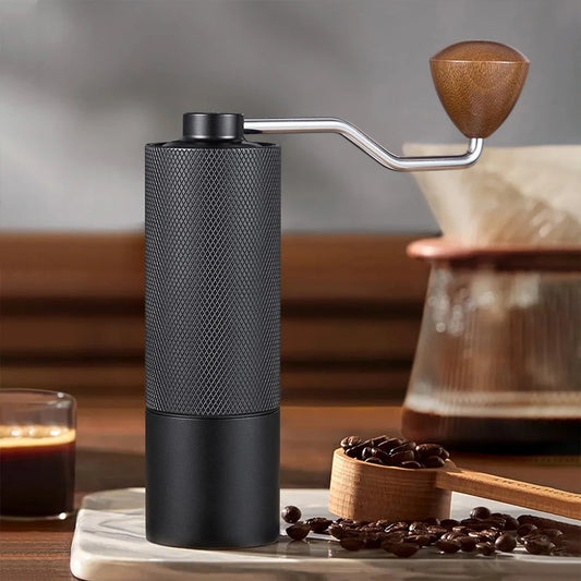 Stainless steel manual coffee grinder with conical burr, adjustable settings, portable hand design, ideal for fresh coffee brewing.