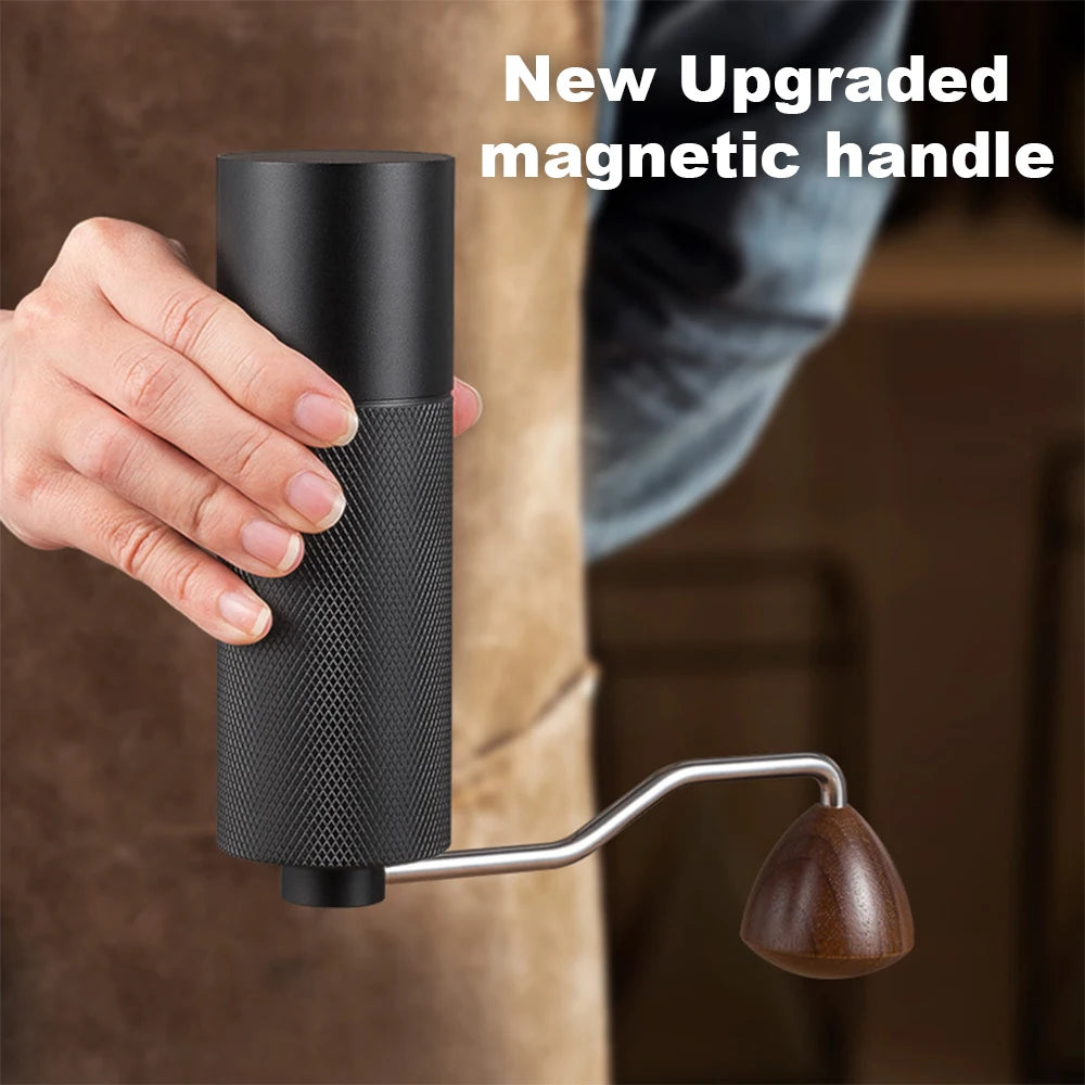 Black stainless steel manual coffee grinder with conical burrs and adjustable settings, portable and high-quality for fresh coffee.