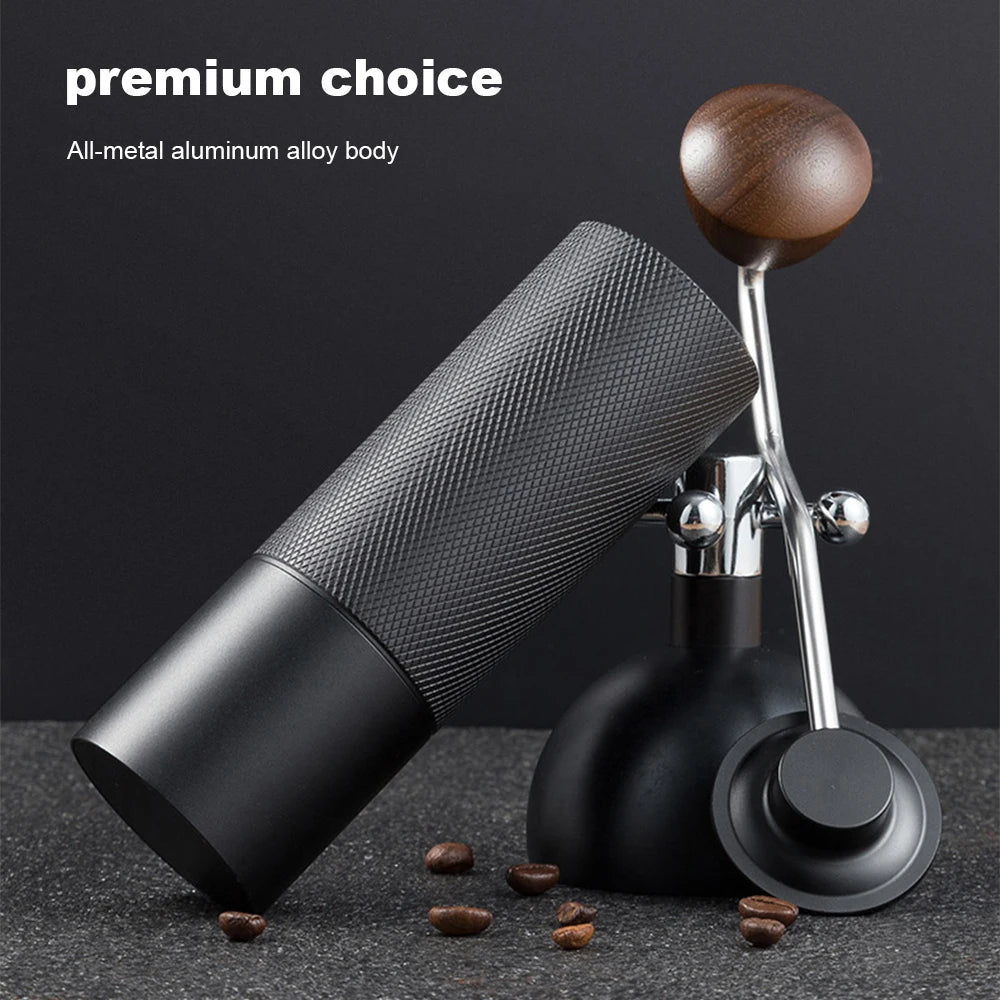 Manual coffee grinder with stainless steel conical burrs, adjustable settings, black finish, portable hand grinder for fresh coffee.