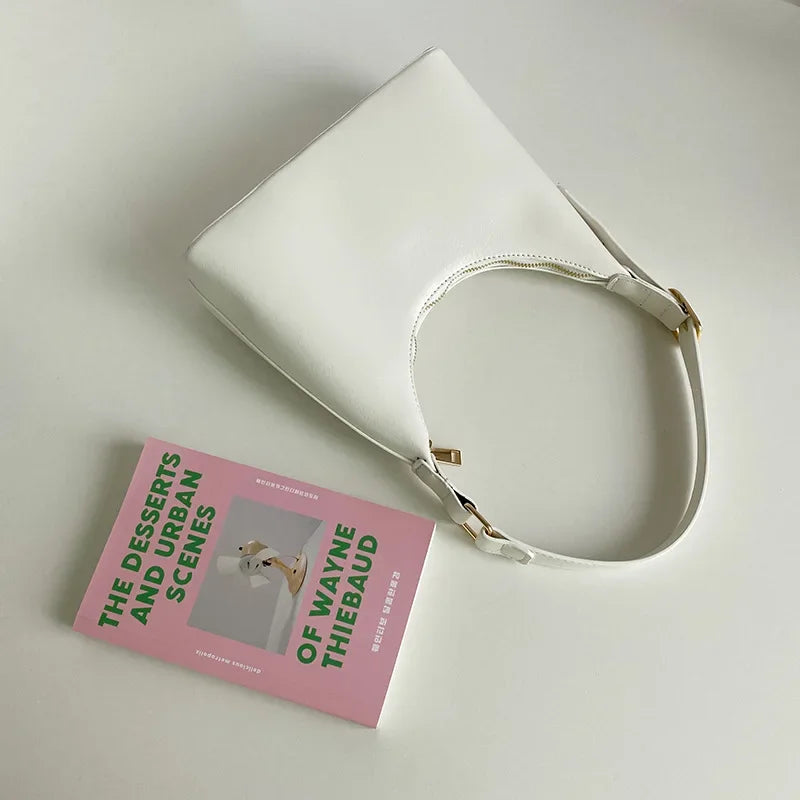 Avocado green women's shoulder handbag with a sleek hobo design, perfect for spring and summer commuting.