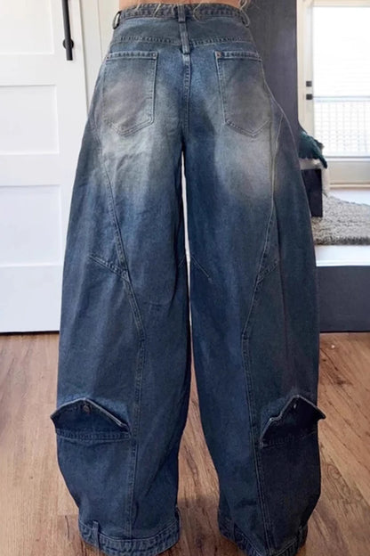 Blue asymmetric women's loose denim jeans with button pockets, washed casual style, suitable for high street and grunge fashion.
