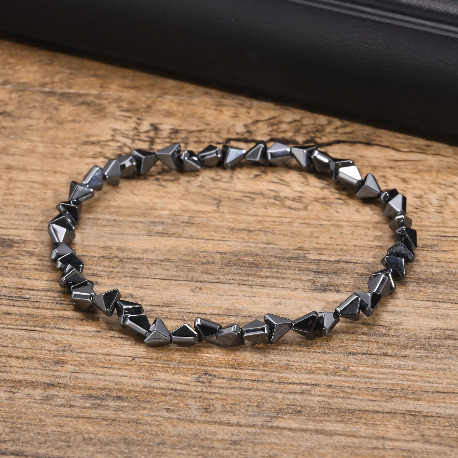 Black triangle beads bracelet for men and women, unisex stretch hematite wristband with handmade design and stylish jewelry appeal.