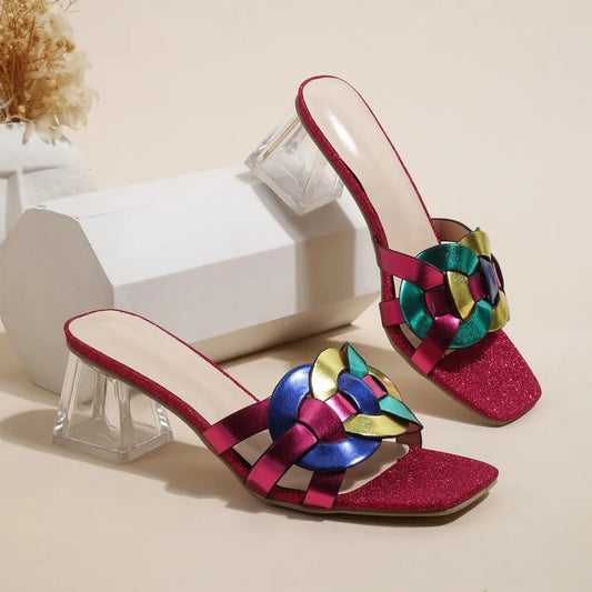 Brown women's summer sandals with square toe, mid-heel, transparent heel, and woven straps, featuring a stylish strappy design.