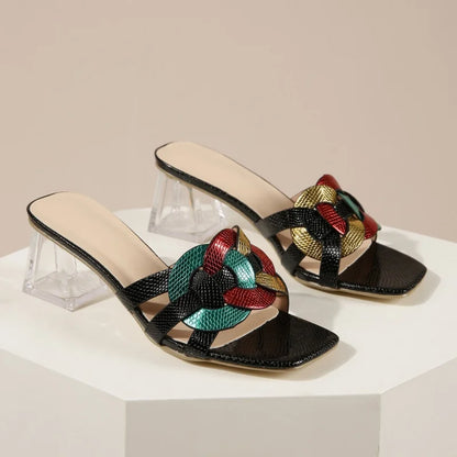 Brown women's summer sandals with square toe, mid-heel, transparent heel, and woven straps, featuring a stylish strappy design.