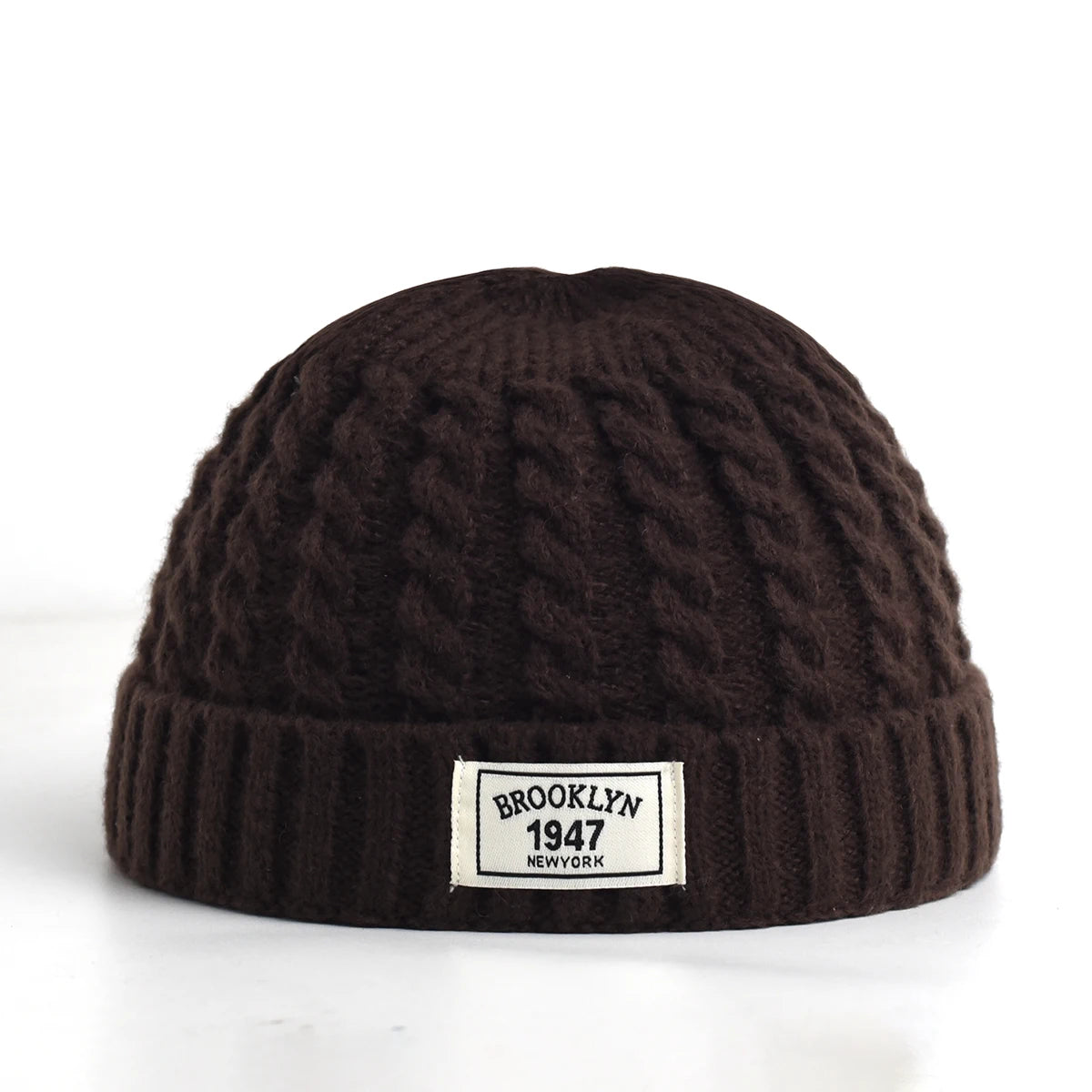 Brown Brooklyn knitted hat for men and women, wool beanie cap with simple, warm, solid design for autumn and winter style.
