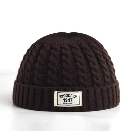 Brown Brooklyn knitted hat for men and women, wool beanie cap with simple, warm, solid design for autumn and winter style.