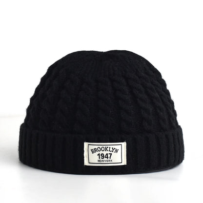 Brown Brooklyn knitted beanie cap for men and women, warm wool fashion skullie with simple, trendy style for autumn and winter.