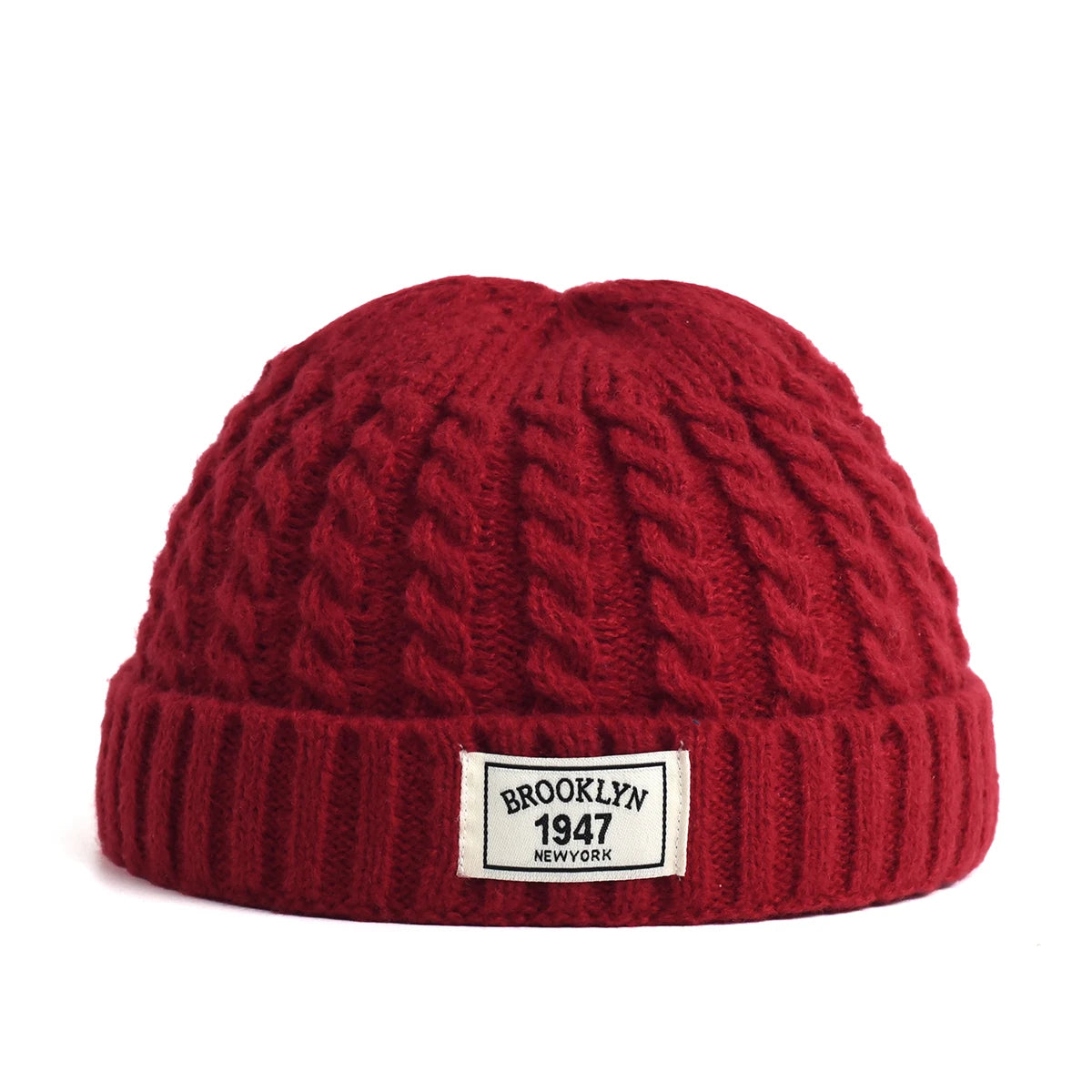 Brown Brooklyn knitted beanie cap for men and women, warm wool hat with a simple, trendy design for autumn and winter wear.