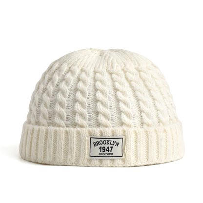 Brown Brooklyn knitted beanie cap for men and women, warm wool skullies with a simple, trendy winter fashion style.