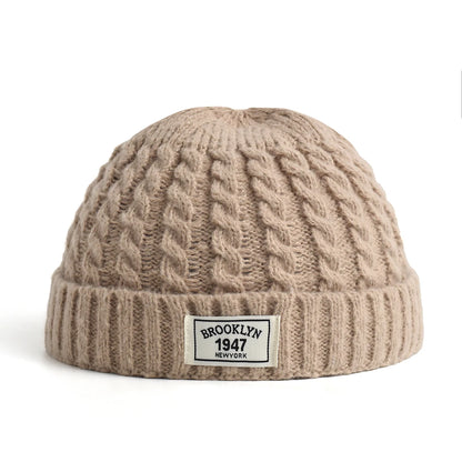 Brown Brooklyn knitted hat for men and women, wool beanie cap with simple, warm, solid design for autumn and winter fashion.