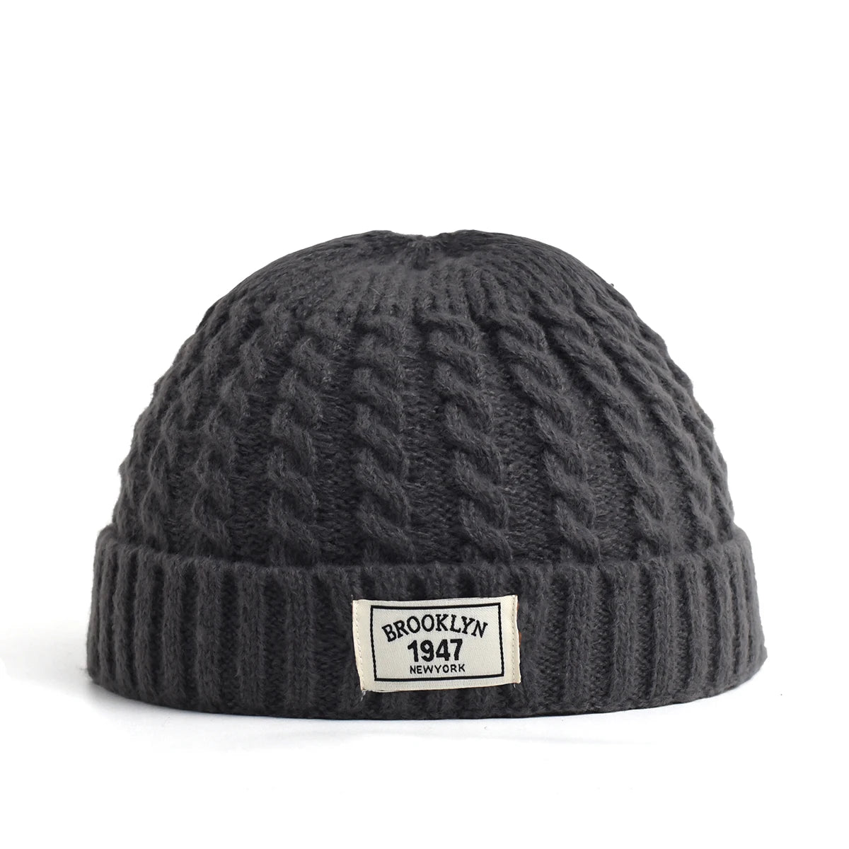 Brown Brooklyn knitted beanie hat for men and women, warm wool cap with simple, trendy design for autumn and winter.