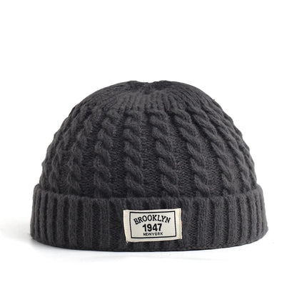 Brown Brooklyn knitted beanie hat for men and women, warm wool cap with simple, trendy design for autumn and winter.