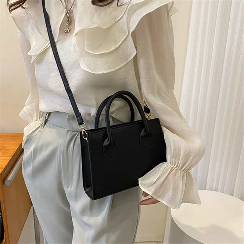 Elegant black handbag with dual handles and crossbody strap, retro style tote for women and girls, suitable for daily use, work, or parties.