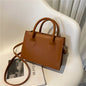 Elegant black handbag with dual handles and crossbody strap, stylish tote for women and girls, suitable for daily wear and parties.