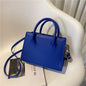 Elegant black handbag with dual handles and a crossbody strap, stylish tote for women and girls, suitable for daily use, work, and parties.
