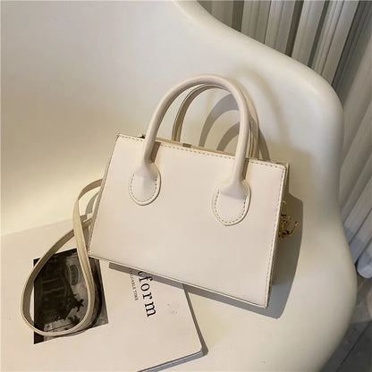 Elegant black handbag with dual handles and crossbody strap, stylish retro tote for women and girls, suitable for daily use or parties.