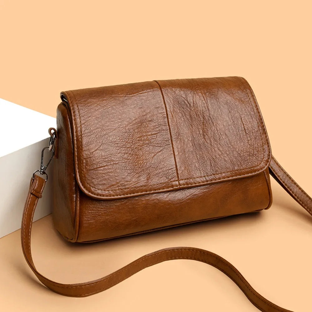 Retro oil wax leather crossbody bag with textured vintage feel, elegant flap design, and adjustable strap.
