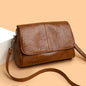 Retro oil wax leather crossbody bag with textured vintage feel, elegant flap design, and adjustable strap.