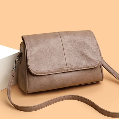 Brown retro oil wax leather crossbody bag with textured vintage look, simple flap design, and adjustable shoulder strap.
