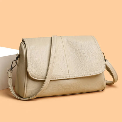 Brown retro oil wax leather crossbody bag with textured vintage feel, elegant flap design, and adjustable shoulder strap.