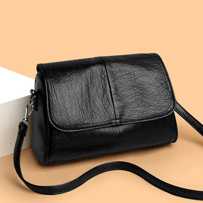 Retro oil wax leather crossbody bag with textured vintage look, elegant flap design, and adjustable strap.