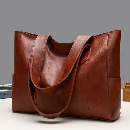 Brown leather tote bag for women, large shoulder handbag with sturdy handles, stylish and spacious for everyday use.