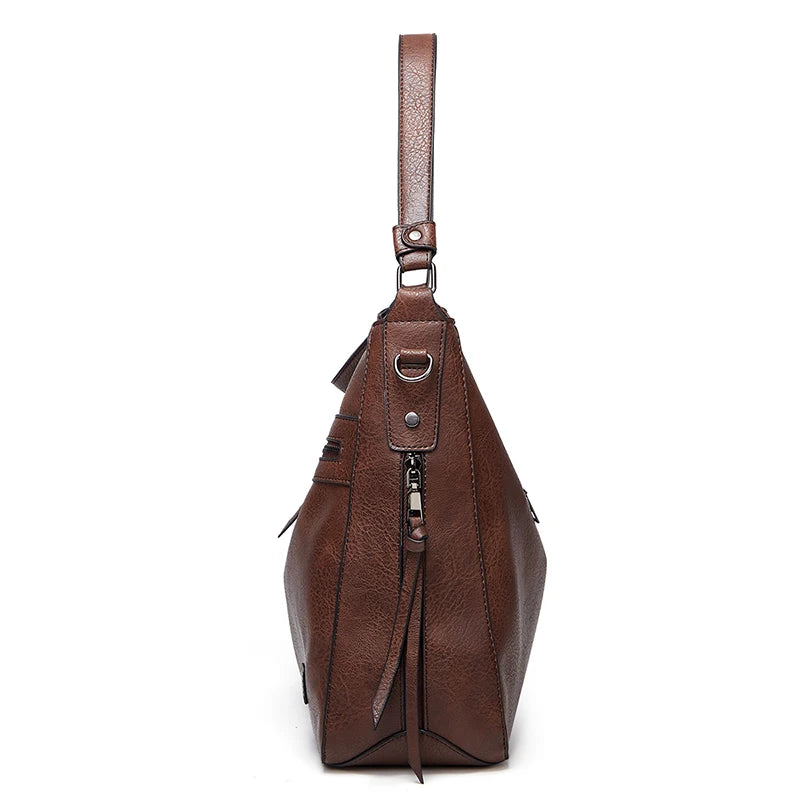 Large burgundy leather women's designer shoulder handbag with feminine style, ideal for travel, outdoor, and winter use.
