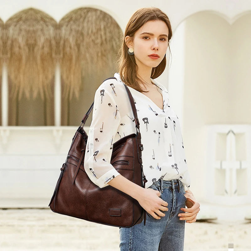Elegant burgundy women's designer shoulder handbag with leather construction, large size, suitable for travel, outdoor, and winter occasions.