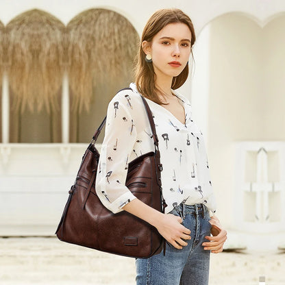Elegant burgundy women's designer shoulder handbag with leather construction, large size, suitable for travel, outdoor, and winter occasions.