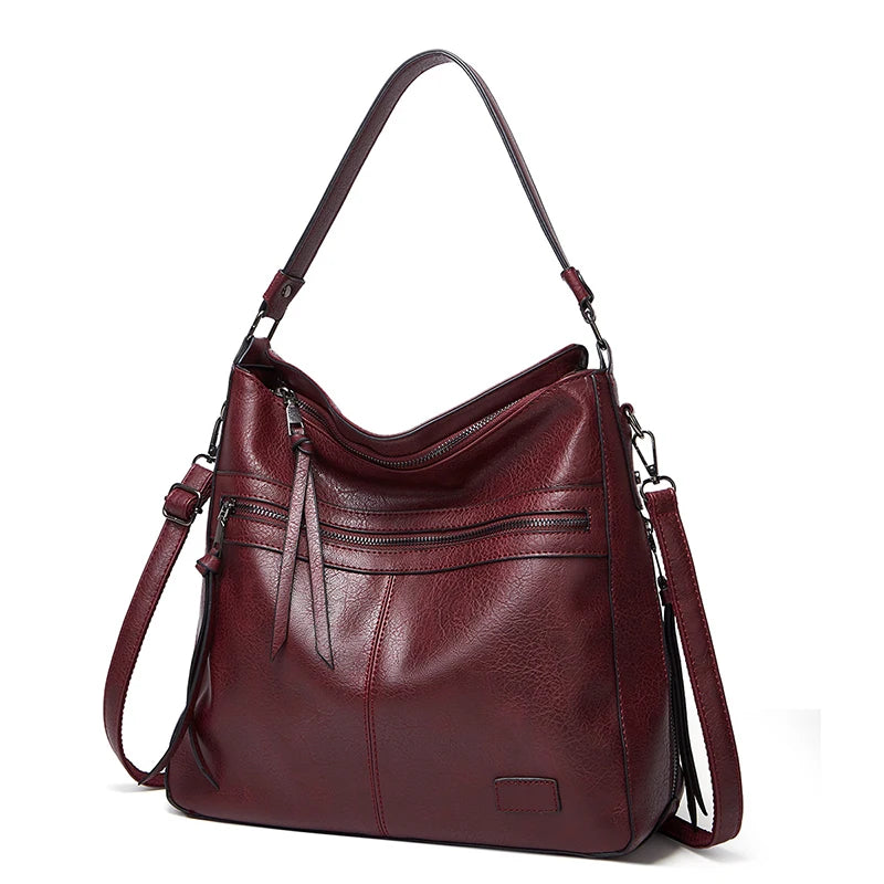 Elegant burgundy leather women's designer shoulder handbag with large messenger style, ideal for travel, weekends, and outdoor use.