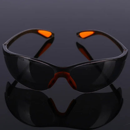 Unisex industrial safety goggles with anti-splash, dustproof, windproof design for cycling and work eye protection.