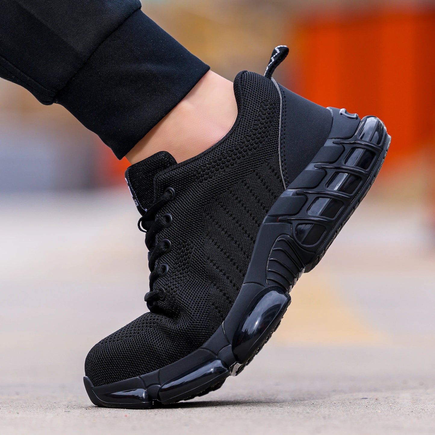 Black steel toe shoes for men, lightweight air-cushioned work sneakers with durable construction and industrial safety features.
