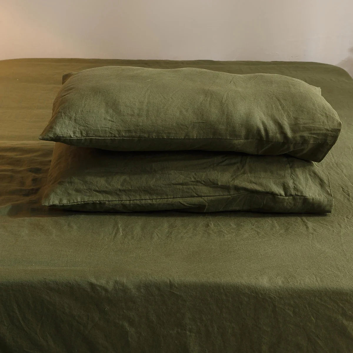 4-piece linen bed sheet set with flat sheet, deep pocket fitted sheet, and pillowcases in natural flax color.