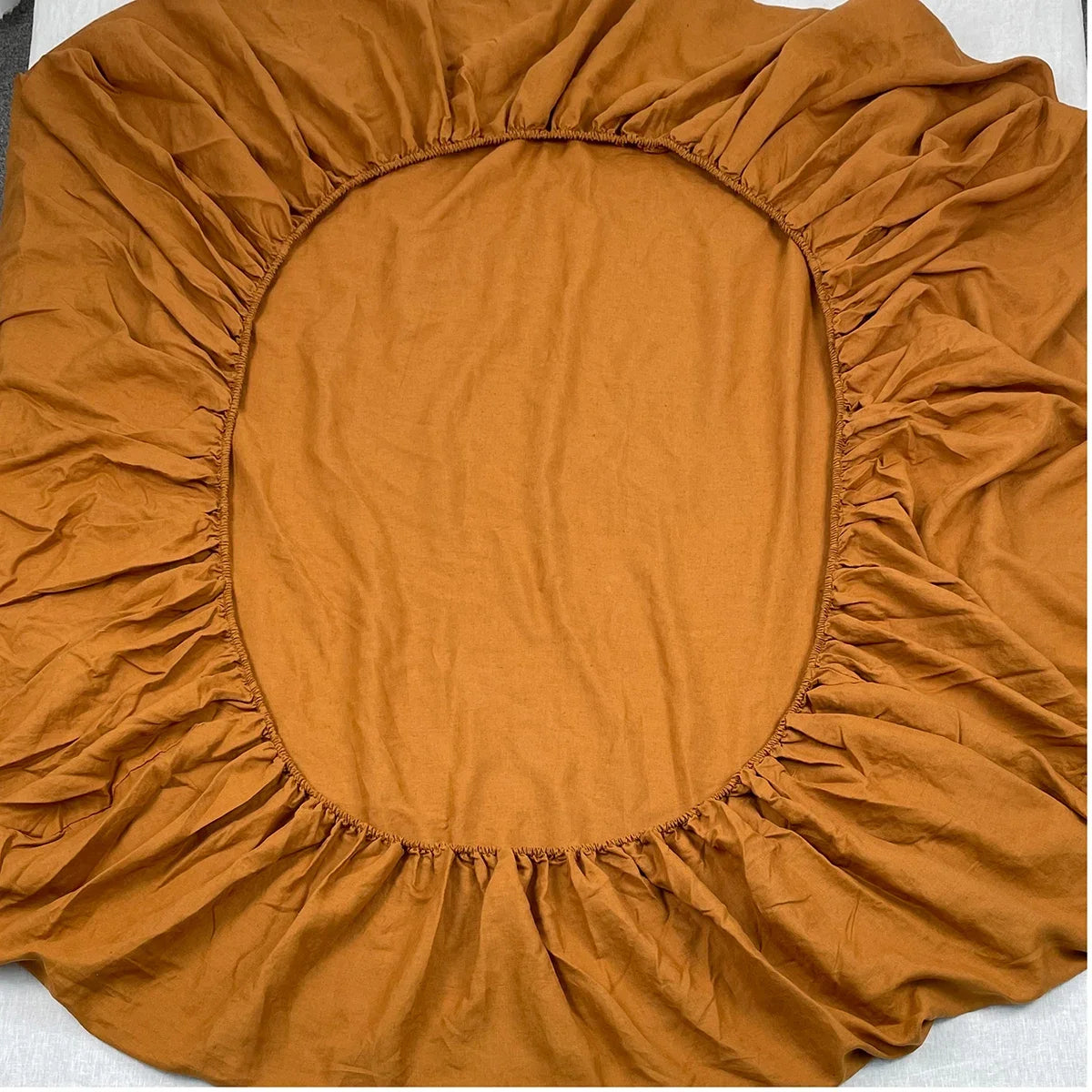 4-piece linen bed sheet set includes flat sheet, fitted sheet with deep pockets, and two pillowcases in natural flax color.