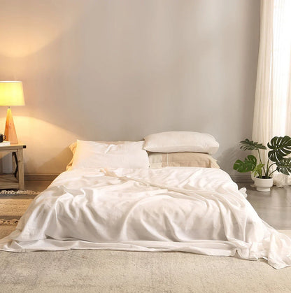 4-piece linen bed sheet set with flat sheet, deep pocket fitted sheet, and two pillowcases in natural flax color