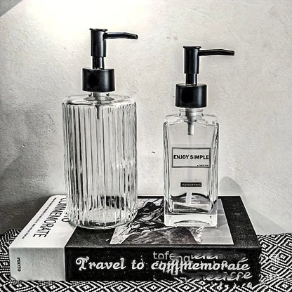 Clear 450ml portable glass hand sanitizer and soap dispenser for bathroom or travel use, with pump and refillable design.