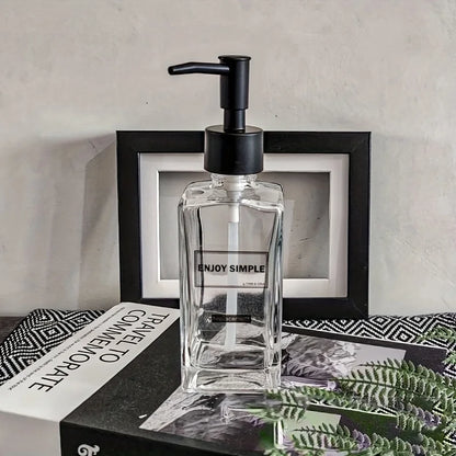Clear 450ml portable glass hand sanitizer and soap dispenser with pump for bathroom, travel, and body wash use.