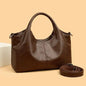 Large capacity women's PU leather handbag with zipper closure, shoulder strap, and multifunctional design in a fashionable coffee color.