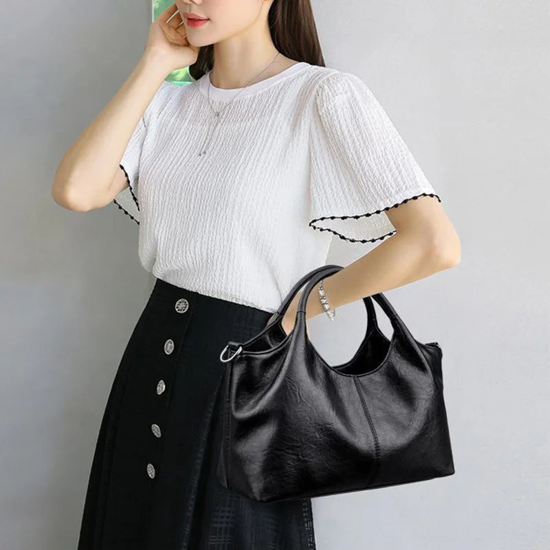 Fashionable large capacity ladies soft PU leather handbag with shoulder strap, crossbody style, zipper closure, and multifunctional design.