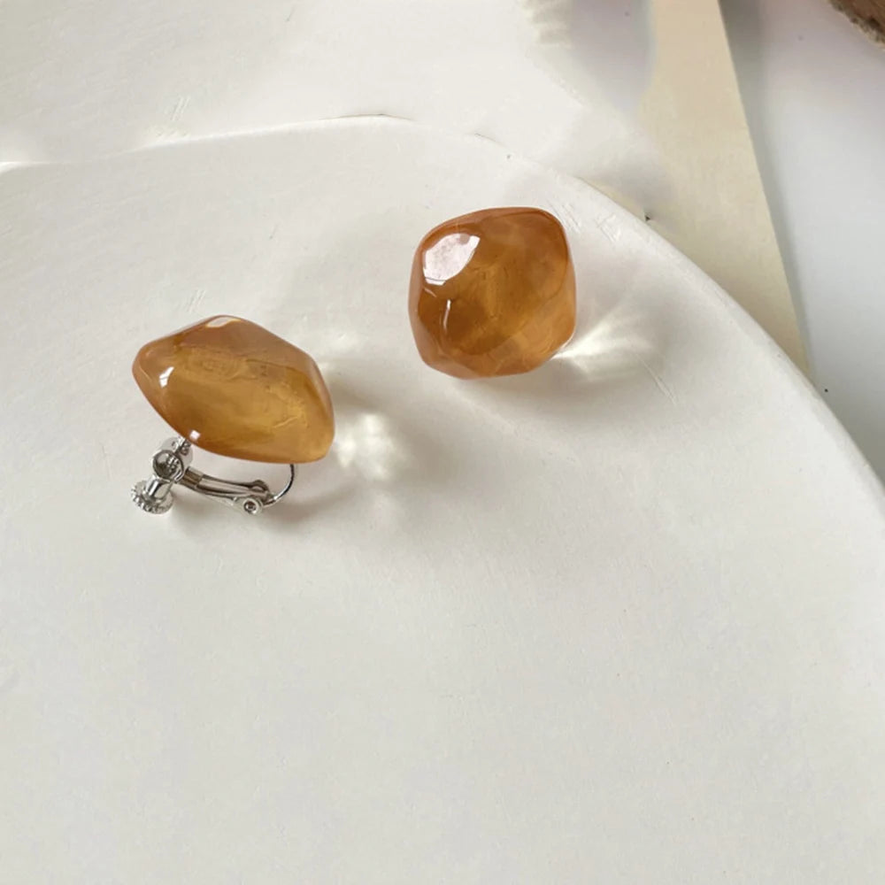 Colorful non-pierced irregular geometric resin ear clip earrings for women, stylish fashion earcuffs with candy hues.