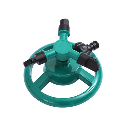 360-degree automatic rotating sprinkler nozzle for garden watering and irrigation, attached to a garden hose in a lush lawn setting.